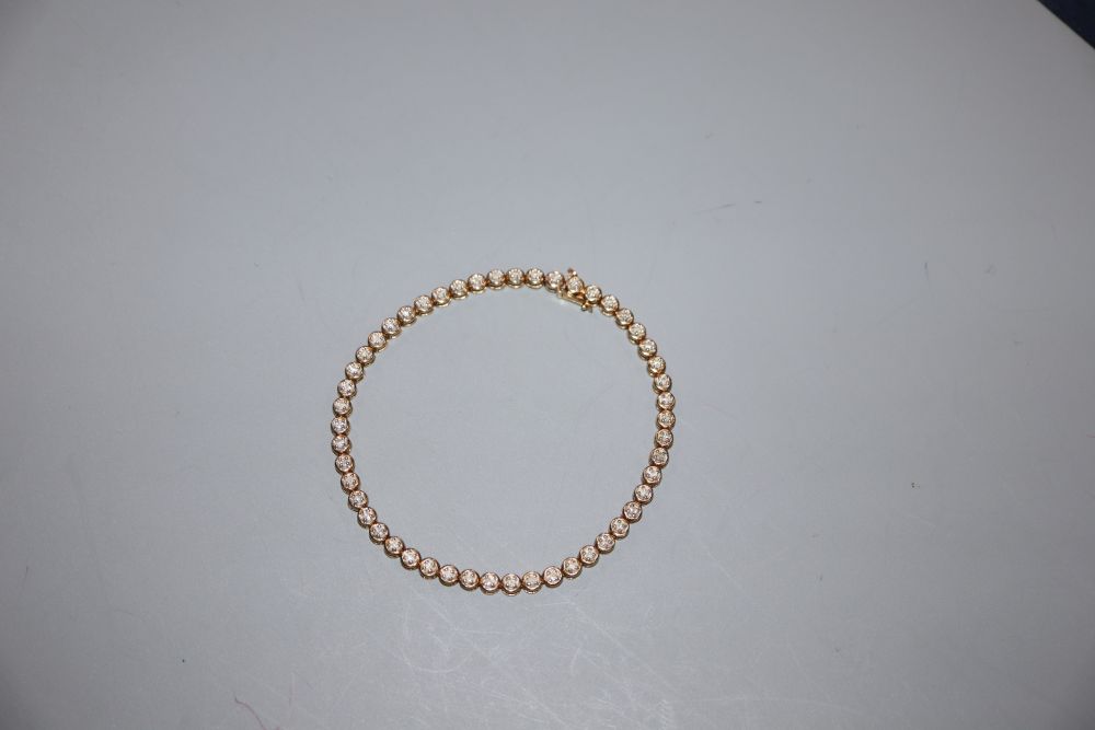 A modern 9ct gold and diamond chip set line bracelet, 18.2cm, gross 5.7 grams.